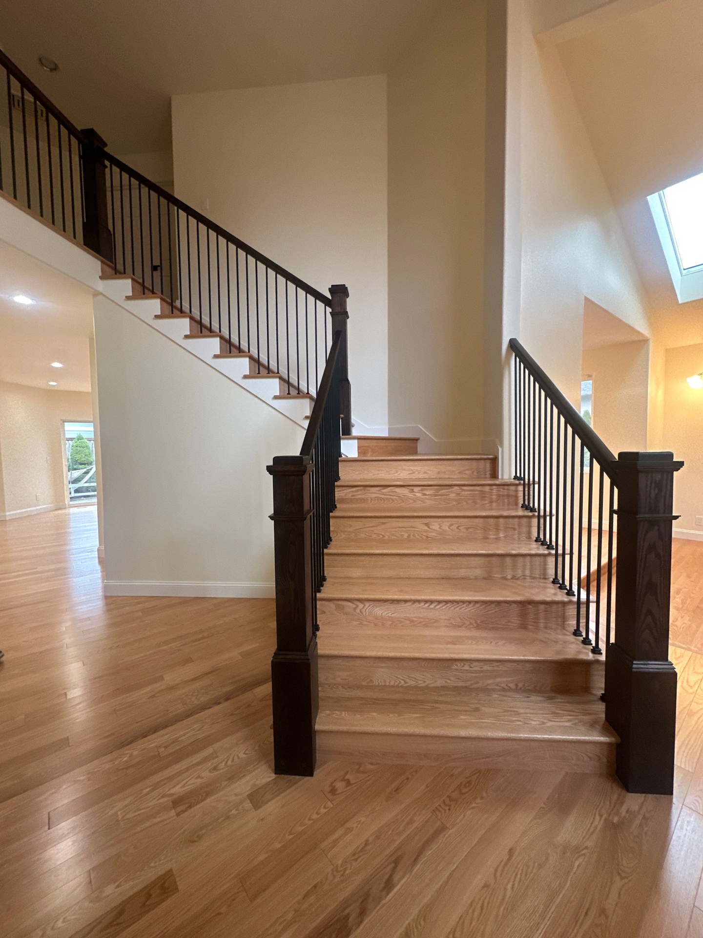After — PNW staircase — cream carpet to white oak & iron